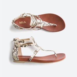 MIA Damari snakeskin thong sandals with zipper.